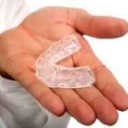 Mouth guard for cutting teeth, which is a symptom of the presence of parasites